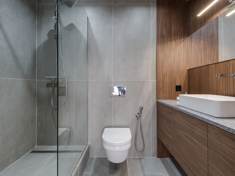 Moderne badkamer met inloopdouche, wandcloset en houten badkamermeubel met opbouwwastafel